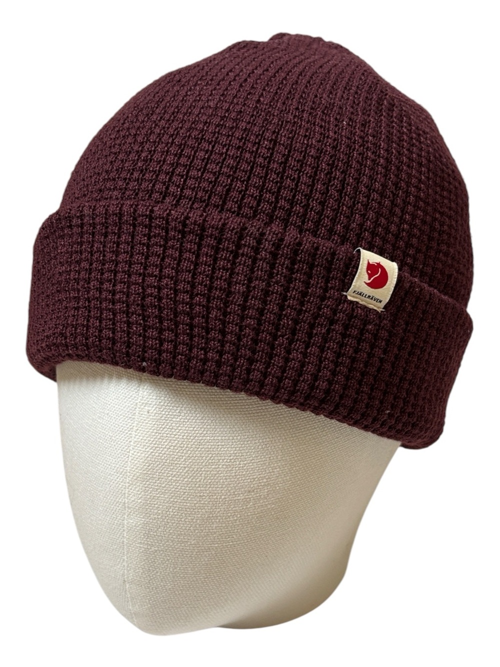 Fjällräven Tab Hat, featuring a cozy textured waffle-knit design in dark garnet.